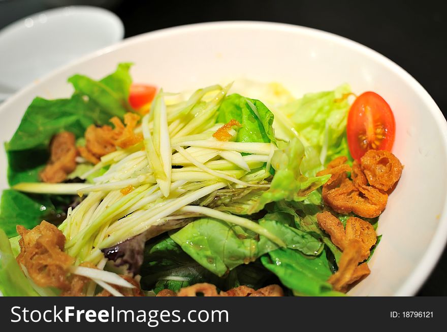 Vegetarian salad from many colorful ingredients as appetizer on white plate. Vegetarian salad from many colorful ingredients as appetizer on white plate.