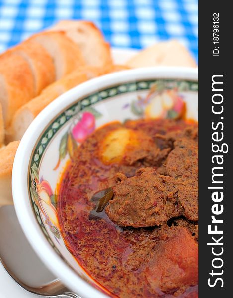 Spicy hot Indian potato and meat curry prepared with a blend of traditional spices. Spicy hot Indian potato and meat curry prepared with a blend of traditional spices.