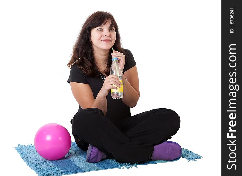 Happy girl drinks water from a bottle. Isolated on white background