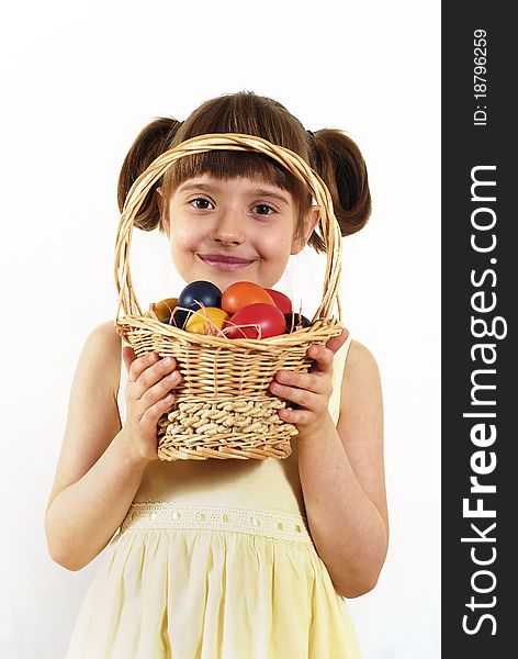 Girl keeping the basket with Easter painted eggs. Girl keeping the basket with Easter painted eggs