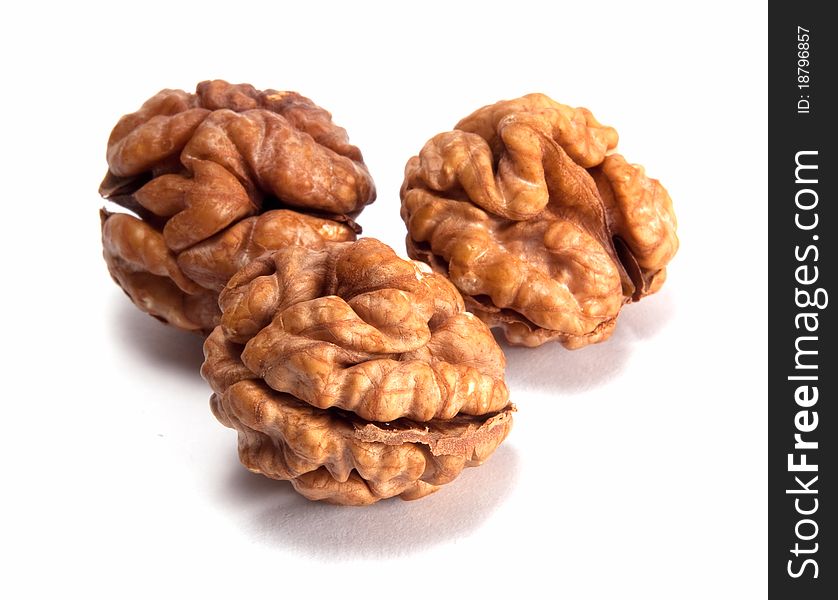 Three walnuts isolated on white background.