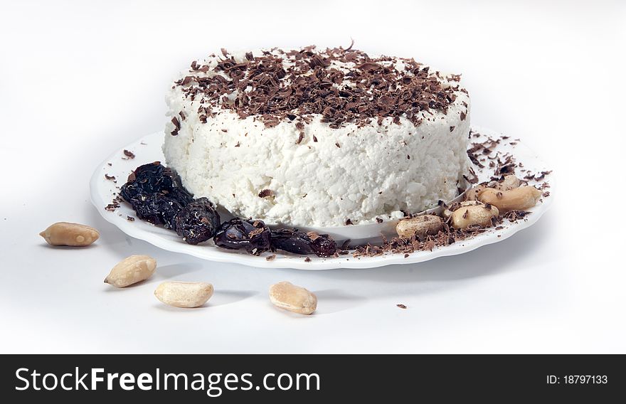 Dairy breakfast, cottage cheese on a plate, strewed by a chocolate crumb on white  background