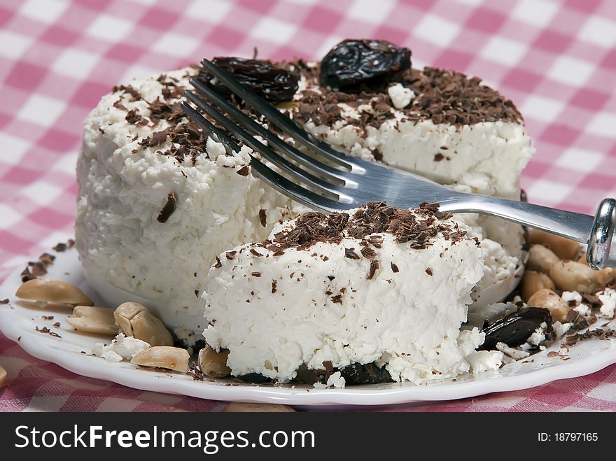 Dairy breakfast, cottage cheese on a plate, strewed by a chocolate crumb on white background