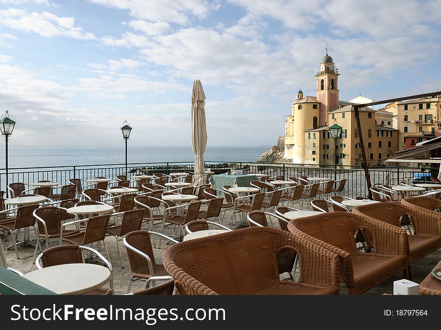 Tables and chairs on the beach in Camogli