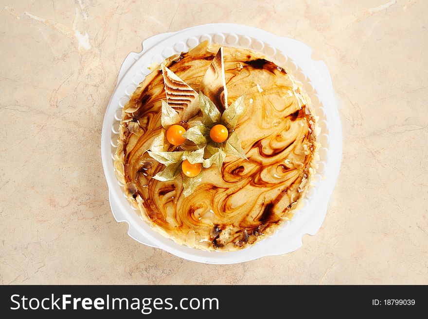 Big caramel pie with decorative berries on table, view from above