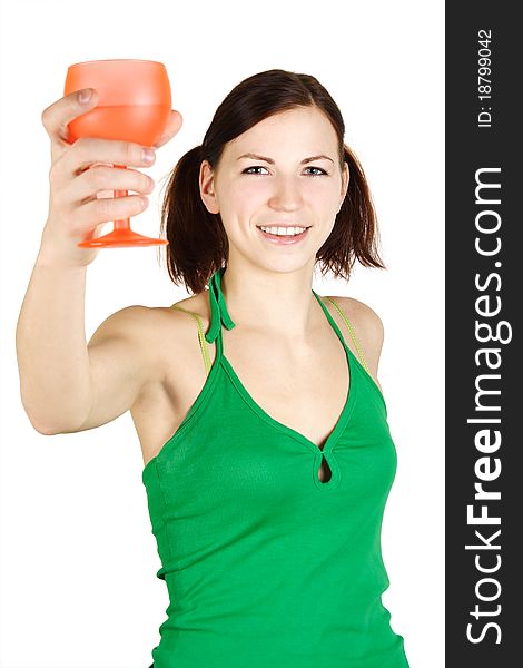 Young girl in green shirt holding orange glass and smiling, isolated. Young girl in green shirt holding orange glass and smiling, isolated