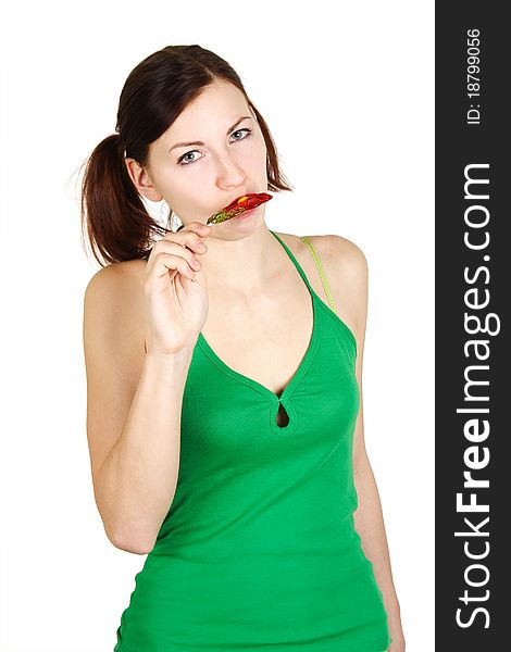 Girl in green shirt eating flower lollipop