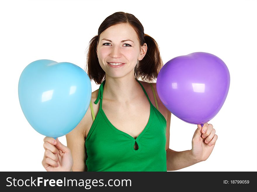 Young girl in green shirt holding balloones and smiling, isolated