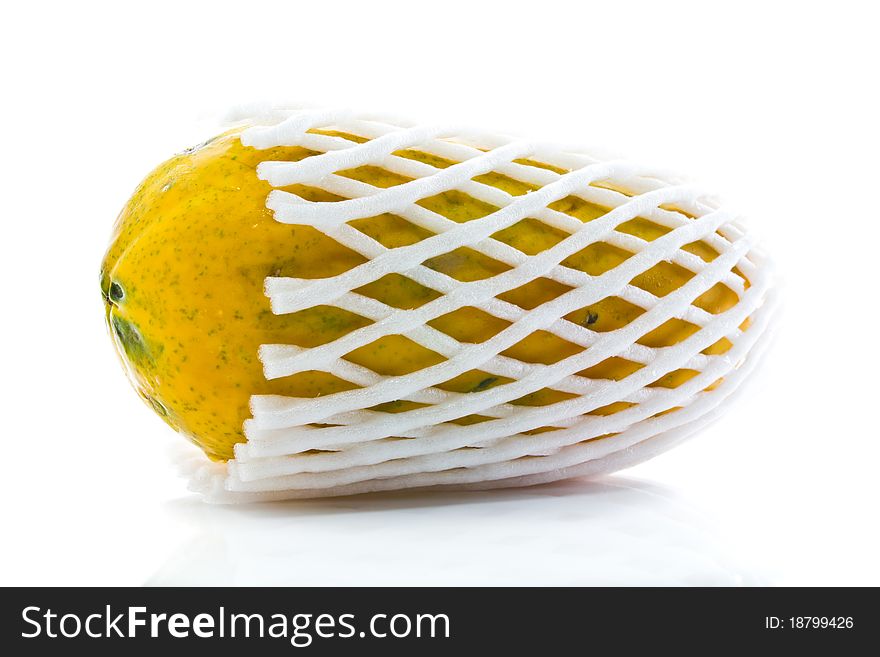 Yellow papaya in foam net isolated on white background