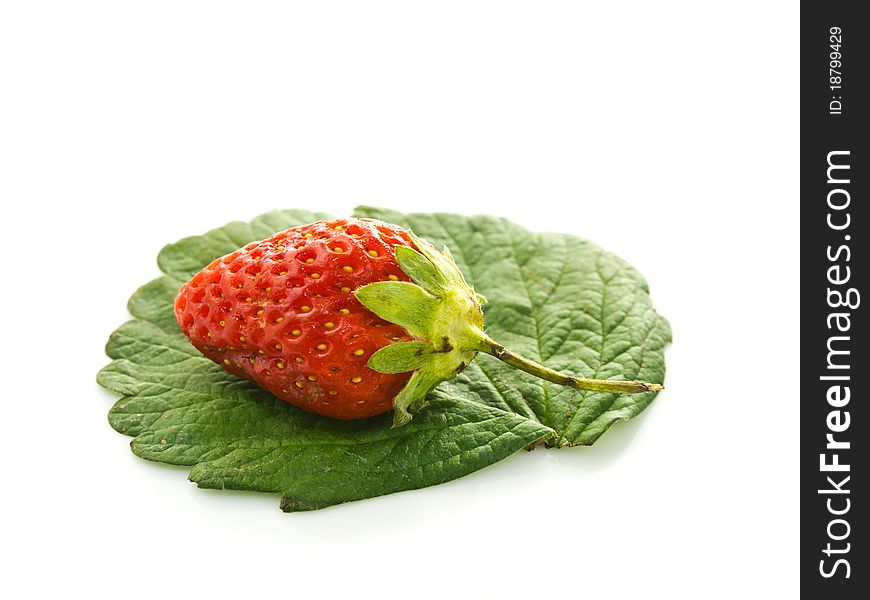 A strawberry on its leaf isolated on white background