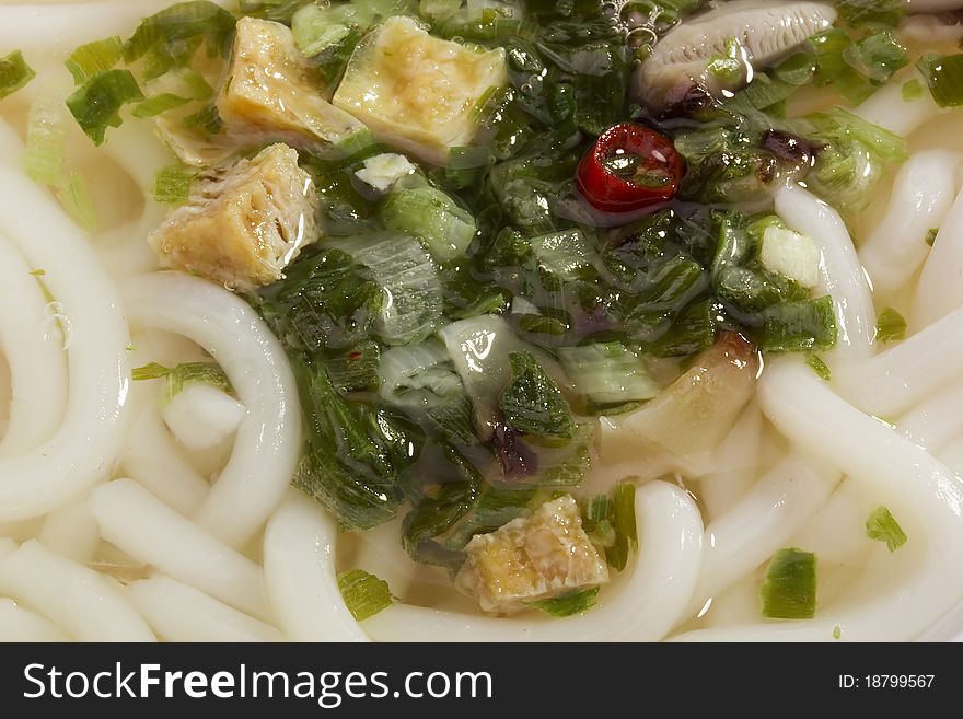 Full frame of sesame chicken flavored soup with noodles. Full frame of sesame chicken flavored soup with noodles.