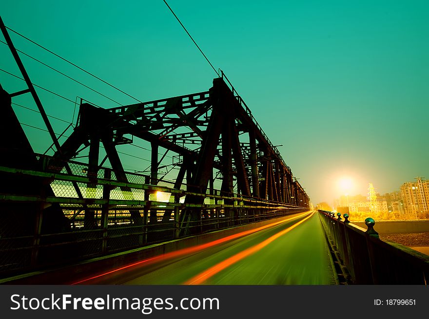 A railway bridge, the train cars and pedestrians