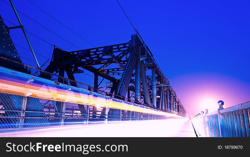 A railway bridge, the train cars and pedestrians