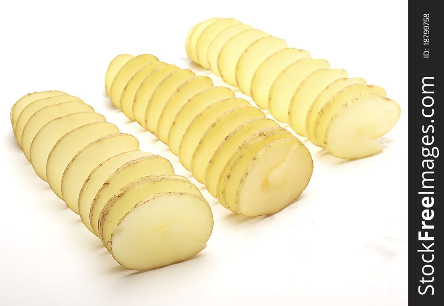 Raw potatoes cut in a spiral shot on a white background