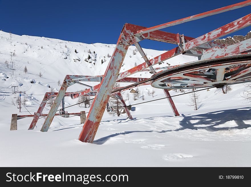 An abandoned chair lift under snow