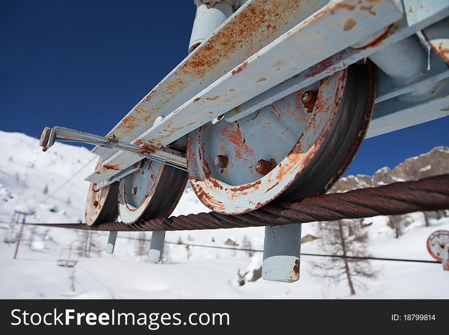 An abandoned chair lift under snow