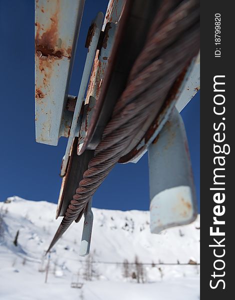 An abandoned chair lift under snow