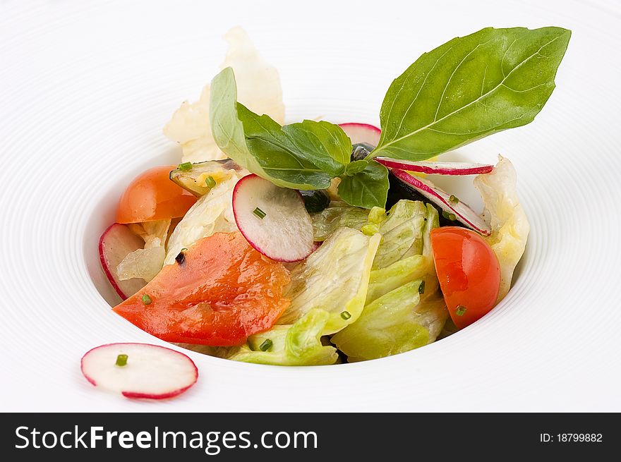 Salad from fresh vegetables close up on a white background