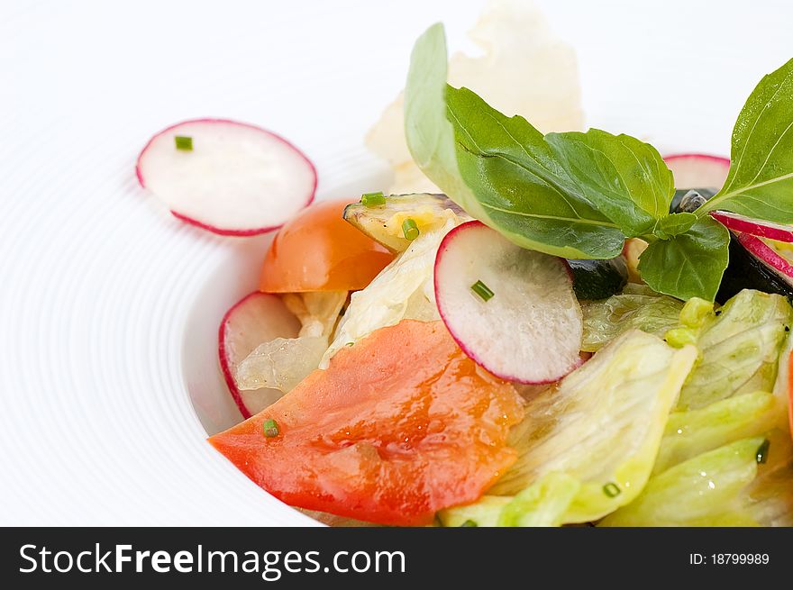 Salad from fresh vegetables close up on a white background