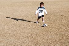 Boy Chasing Football Stock Photo Boy Chasing Football Stock Photo