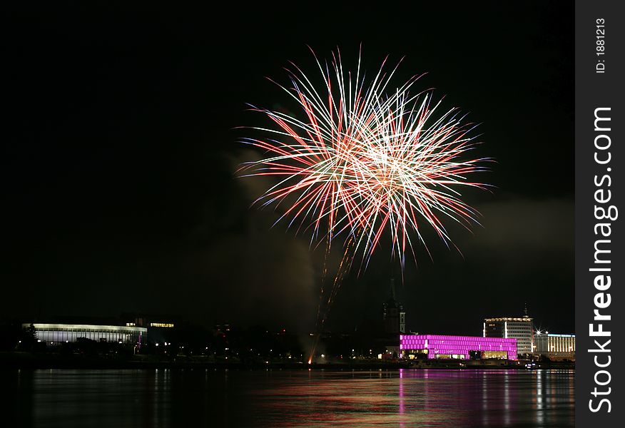 Fireworks in Linz (Austria) at the Danube river with beautiful reflections. On the right side the Brucknerhaus (orchestra house) on the left the Lentos (Museum) with its illuminated walls. Fireworks in Linz (Austria) at the Danube river with beautiful reflections. On the right side the Brucknerhaus (orchestra house) on the left the Lentos (Museum) with its illuminated walls.