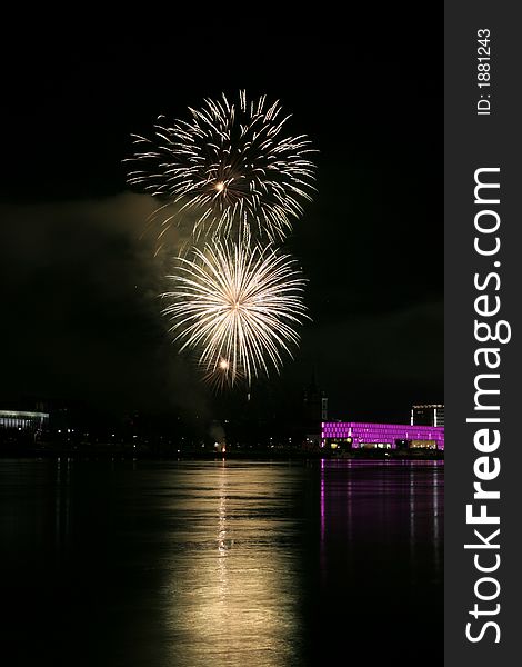 Fireworks in Linz (Austria) at the Danube river with beautiful reflections. On the right side the Brucknerhaus (orchestra house) on the left the Lentos (Museum) with its illuminated walls. Fireworks in Linz (Austria) at the Danube river with beautiful reflections. On the right side the Brucknerhaus (orchestra house) on the left the Lentos (Museum) with its illuminated walls.