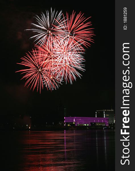 Fireworks in Linz (Austria) at the Danube river with beautiful reflections. On the right side the Brucknerhaus (orchestra house) on the left the Lentos (Museum) with its illuminated walls. Fireworks in Linz (Austria) at the Danube river with beautiful reflections. On the right side the Brucknerhaus (orchestra house) on the left the Lentos (Museum) with its illuminated walls.