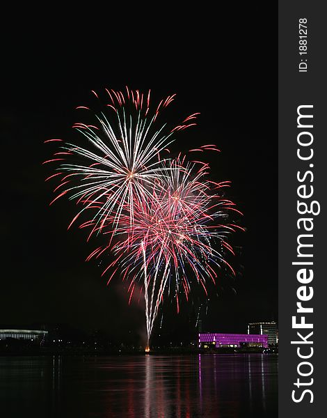 Fireworks in Linz (Austria) at the Danube river with beautiful reflections. On the right side the Brucknerhaus (orchestra house) on the left the Lentos (Museum) with its illuminated walls. Fireworks in Linz (Austria) at the Danube river with beautiful reflections. On the right side the Brucknerhaus (orchestra house) on the left the Lentos (Museum) with its illuminated walls.