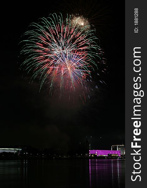 Fireworks in Linz (Austria) at the Danube river with beautiful reflections. On the right side the Brucknerhaus (orchestra house) on the left the Lentos (Museum) with its illuminated walls. Fireworks in Linz (Austria) at the Danube river with beautiful reflections. On the right side the Brucknerhaus (orchestra house) on the left the Lentos (Museum) with its illuminated walls.