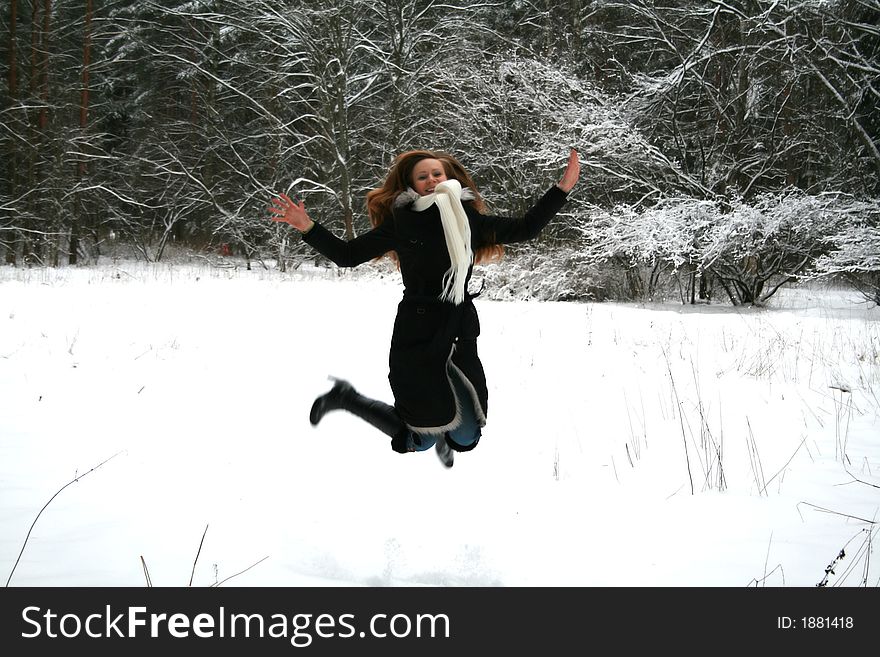 The girl jumps in winter park, motion blur