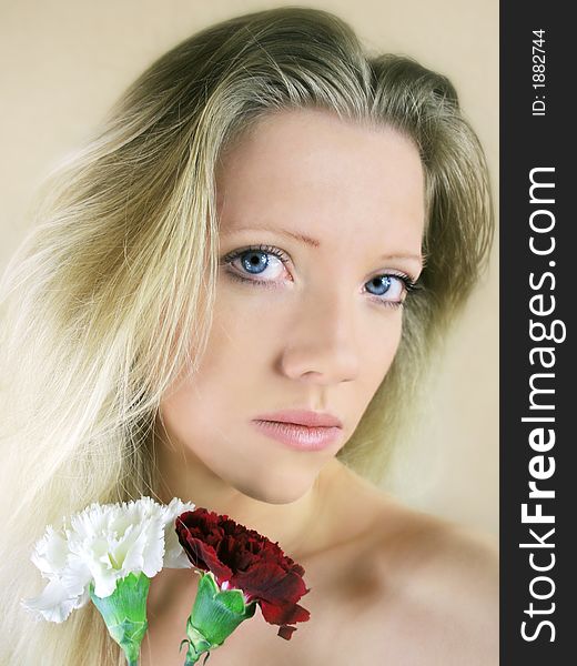 Portrait of a fresh, beautiful young blond woman with some flowers in her hand - valentine ´s day. Portrait of a fresh, beautiful young blond woman with some flowers in her hand - valentine ´s day