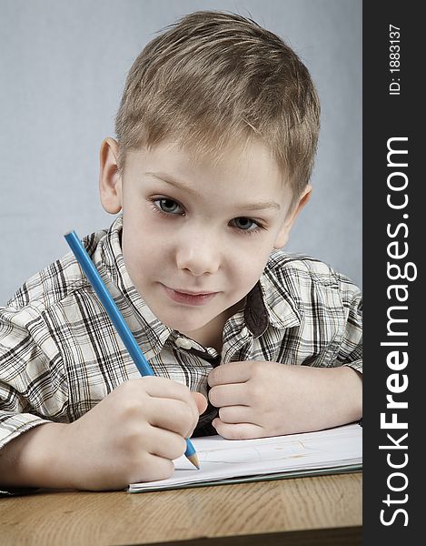 Smiling drawing boy with notepad and pencil. Smiling drawing boy with notepad and pencil