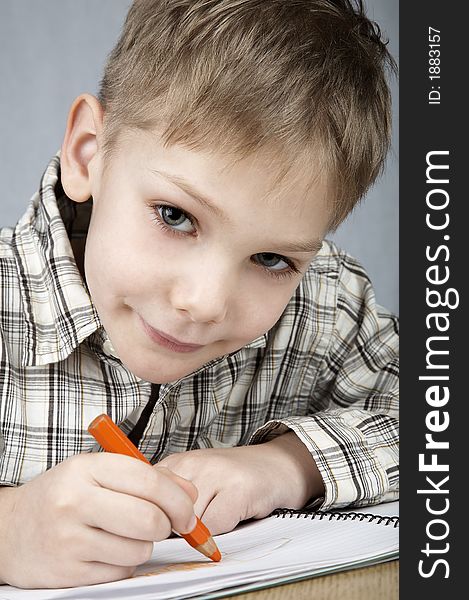 Smiling drawing boy with notepad and pencil. Smiling drawing boy with notepad and pencil