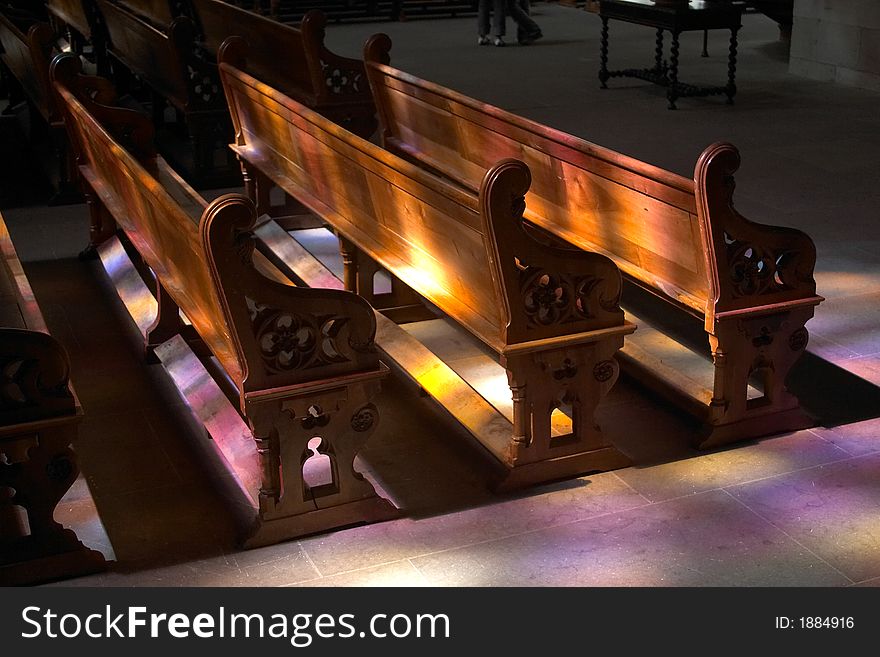 Colorful ray of lights on some benches inside St Peters Cathedral, Geneva, Switzerland. Colorful ray of lights on some benches inside St Peters Cathedral, Geneva, Switzerland.