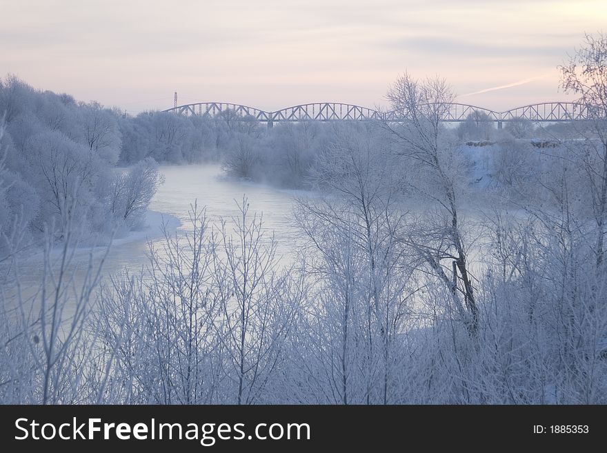 Winter morning view with snowy trees and river. Winter morning view with snowy trees and river