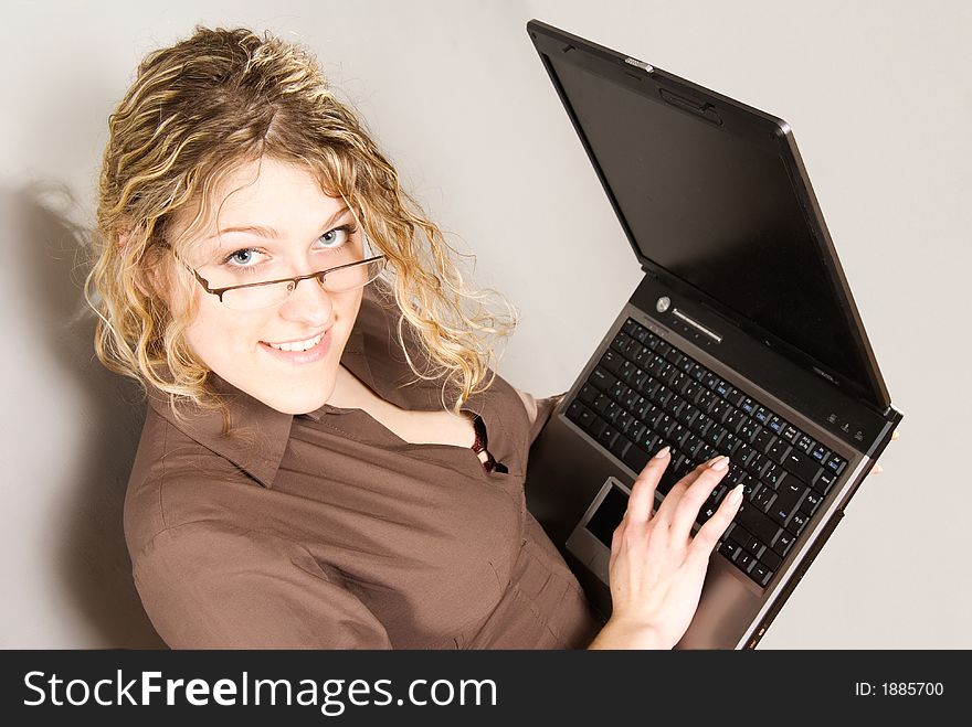 Businesswoman with glasses holding laptop computer. Businesswoman with glasses holding laptop computer