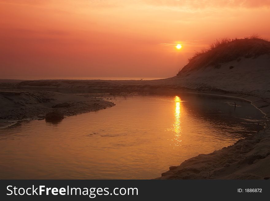 Orange sunset over coastline of Baltic sea