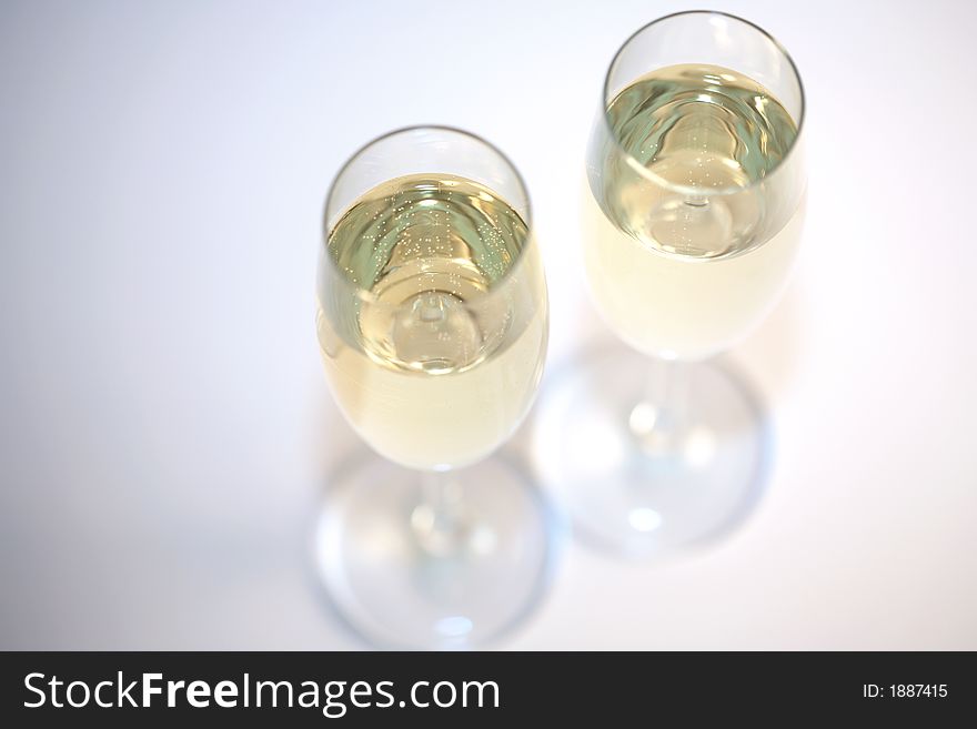 Two glasses of sparkeling wine and a white background