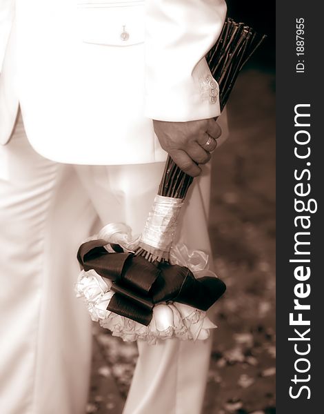 Closeup of groom holding a bouquet. Closeup of groom holding a bouquet