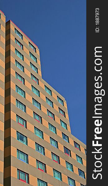 Highrise apartment building with different  colored windows. Highrise apartment building with different  colored windows