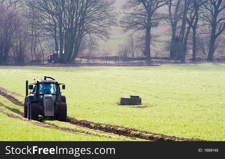 Tractor and trailer on Farm in England on a winters day. Tractor and trailer on Farm in England on a winters day.