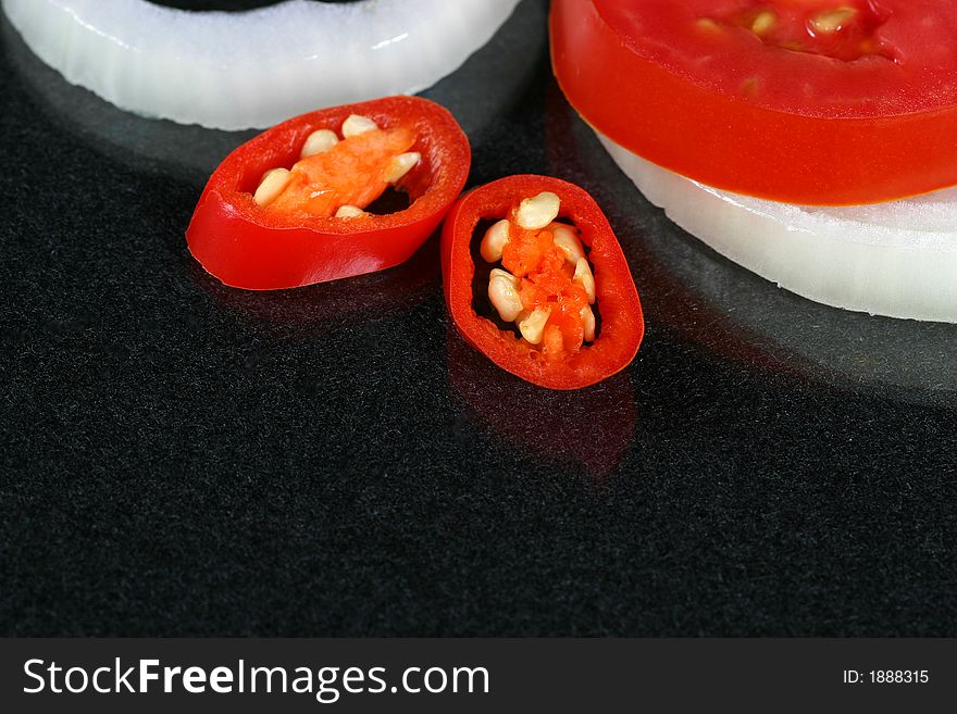 Tomato, Onion And Chilli In Piece On The Black Background