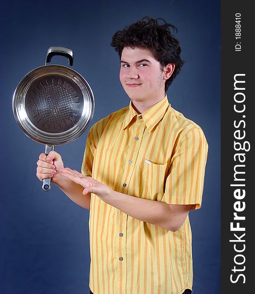 Young funny cooker with empty baking dish