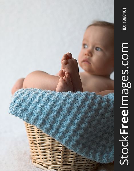 Image of baby sitting in a basket. Image of baby sitting in a basket