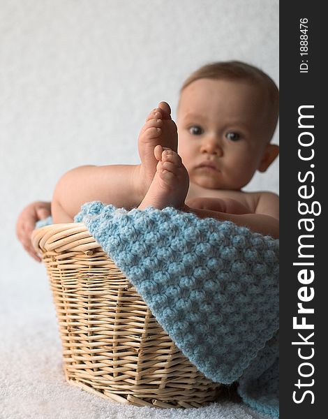 Image of baby sitting in a basket. Image of baby sitting in a basket