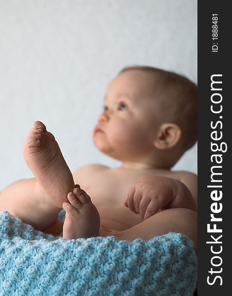 Image of baby sitting in a basket. Image of baby sitting in a basket