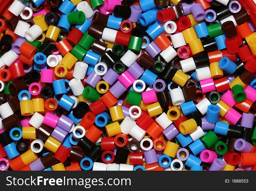 A macro shot of a bunch of small plastic thingies, all kinds of colors. A macro shot of a bunch of small plastic thingies, all kinds of colors.