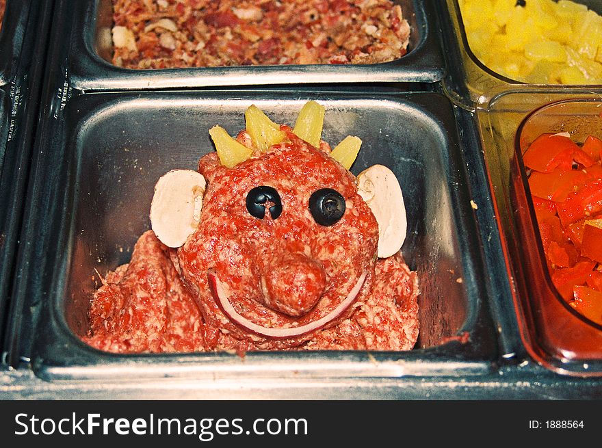 Clown face made from pizza toppings. Clown face made from pizza toppings