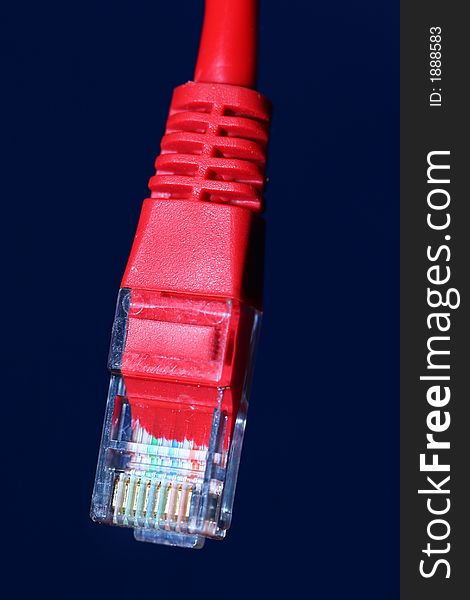 A macro shot of a red network cable with a rj45 connector. A macro shot of a red network cable with a rj45 connector