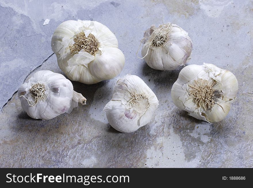 Garlic cloves on a slate background